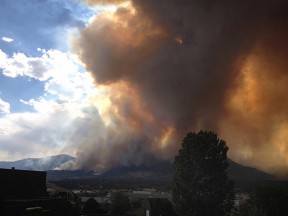 A large plume of smoke rises over Colorado Springs, Colo., that cast a wide, dark shadow over homes and businesses. Wildland fires burn intensely and creating a defensible space around your home can be the difference between a close call and complete destruction. (Adam Drake/Inciweb.org)