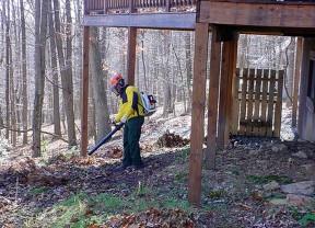 Don’t forget to clean anything stored underneath decks and porches and remove vegetation as a precaution against wildland fires. Leaves, twigs and other debris act as fuels that feed a blaze. Keep leaves and needles off of your roof and deck and make a fuel-free area within 3-5 feet of your home’s perimeter. (Photo used by permission from the National Fire Protection Association Firewise Communities Program)