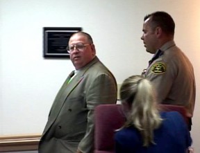 Winkler is escorted from the dias June 18 after the board voted to vacate his seat on grounds he did not maintain a residence in the school district, as state law requires.