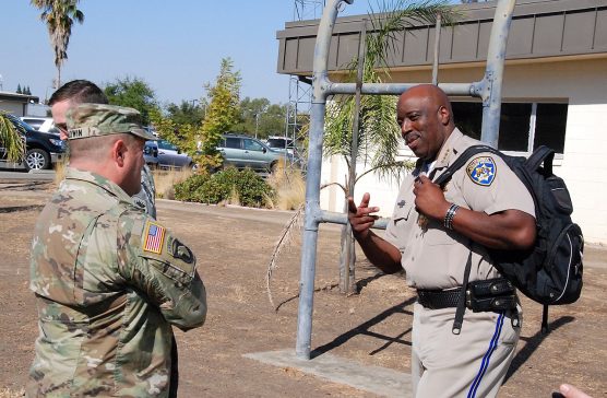 The California National Guard's Adjutant General Maj. Gen. David S. Baldwin (left) speaks with then-Acting California Highway Patrol Commissioner Warren Stanley before an air and ground survey of Northern California fires near Santa Rosa, California, Oct. 14, 2017. (Army National Guard photo by Capt. Will Martin/Released).