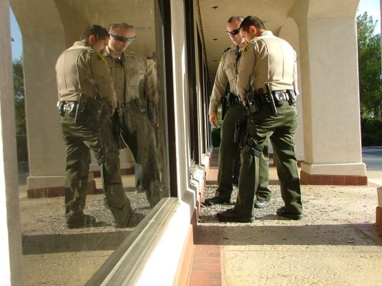 SCV Sheriff's Station deputies check out the broken window at the Valencia Post Office in Creekside Sunday afternoon. | Photo: Kevin Gilly/two8nine media.