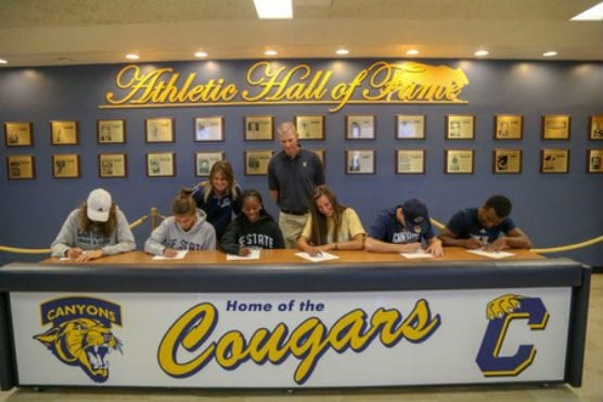 College of the Canyons track & field student-athletes (from left) Marcel Sylvester, Stephanie Martinez, Díani Ellis, Sophia Stephan, Slade Cavallaro and Leo Lambert take part in a signing day ceremony as COC track & field head coach Lindie Kane and associate athletic director Chad Peters look on. | Photo: Jesse Muñoz/COC Sports Information Director.