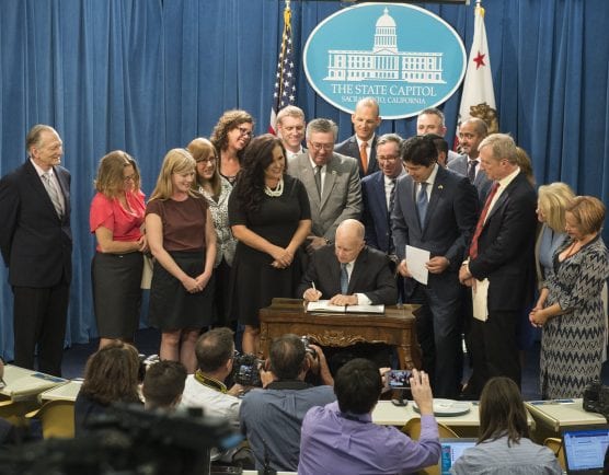 Gov. Jerry Brown signs SB 100, mandating 100 percent renewable energy in California by 2045, on Sept. 10, 2018.