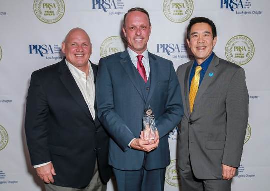 Roger Frizzell (left), chief communications officer for Princess Cruises parent company Carnival Corporation was joined by Princess Cruises' chief marketing officer of Gordon Ho (right) to present Brian O’Connor (center) with PR Professional of the Year honors at the 54th Annual PRSA-LA PRism Awards on Oct. 17.