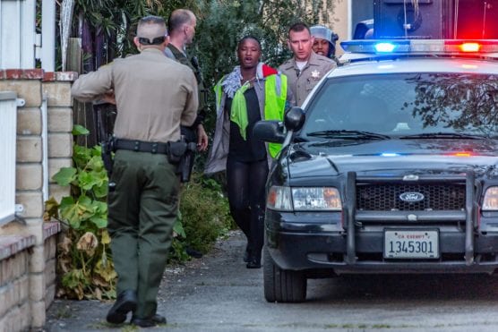 A woman is taken into custody in connection with a barricade situation on the 24700 block of Newhall Avenue Friday afternoon. | Photo: Cory Rubin/The Signal.