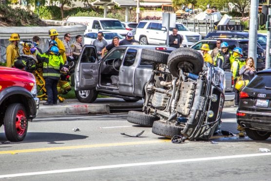 Los Angeles County firefighters and American Medical Response EMTs work to transport victims of a three-vehicle crash involving a rollover as deputies examine the wreckage near the intersection of Decoro Drive and McBean Parkway in Valencia. | Photo: Austin Dave/The Signal.