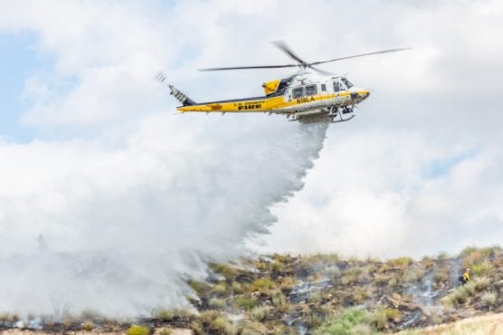 Los Angeles County Fire Copter 18 drops water on a small brush fire near Sand Canyon Road in Canyon Country Monday afternoon. | Photo: Cory Rubin/The Signal.