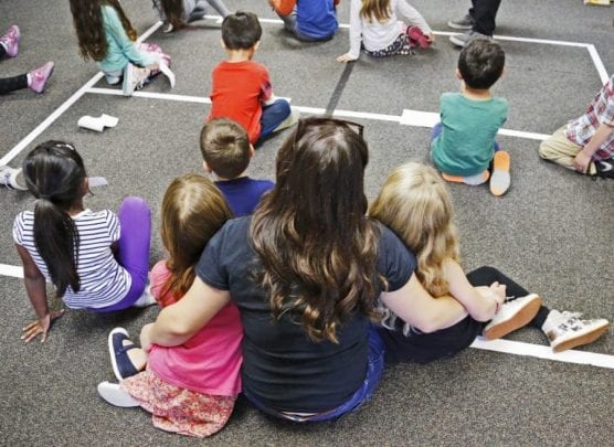 Kids sit close to a counselor during an activity teaching kindness at Saugus High School's Students Matter Club's Sunshine Day Camp at Stevenson Ranch Elementary School on Friday, April 7, 2017. File photo by Katharine Lotze/The Signal.