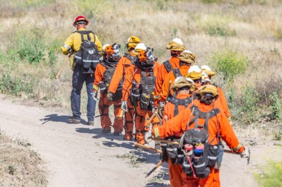 A Los Angeles County camp crew makes its way to a small spot fire in the hills near a home off of Wesley Way in Canyon Country. | Photo: Cory Rubin/The Signal.