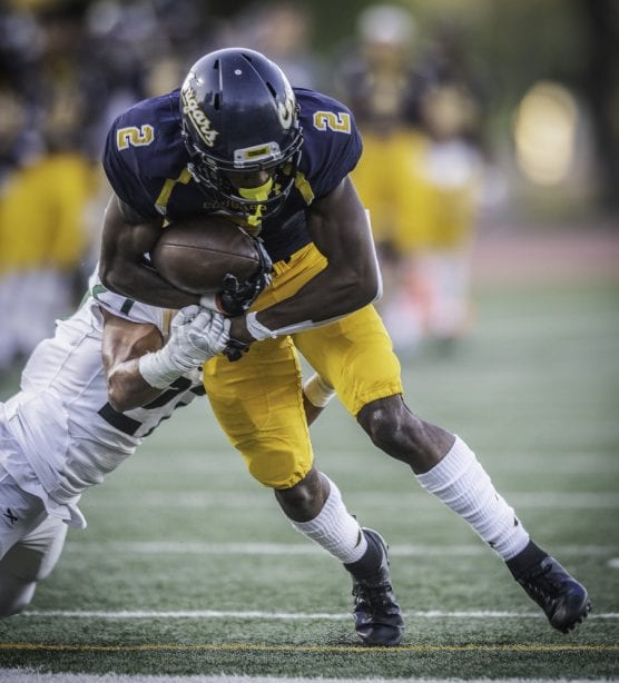College of the Canyons’ Alonzell Henderson is brought down by Grossmont College’s Joel Mewis after getting a first down in the first half Saturday, September 14, 2019 at COC. The Cougars beat Grossmont 41-13. Henderson had seven receptions for 101 yards and a touchdown in the win for Canyons. | Photo: Kevin Karzin.