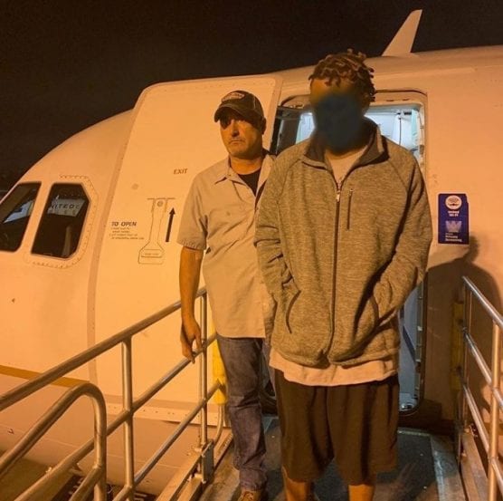 Det. Dan Finn emerges from a plane in Burbank Wednesday with drive-by shooting suspect Kenneth Mitchell. | Photo courtesy SCV Sheriff's Station.