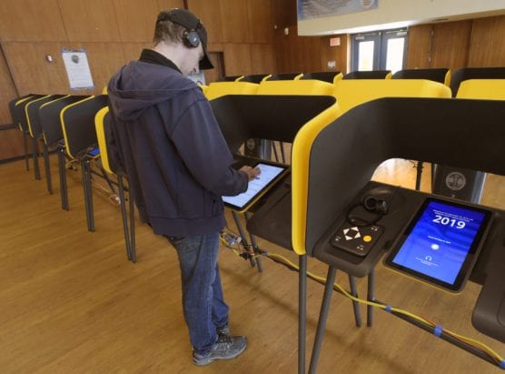 Kyle Write read the prompts while using the headphones in the electronic booths during a mock election held at College of the Canyons in Valencia on Saturday, September 28, 2019. | Photo: Dan Watson/The Signal.