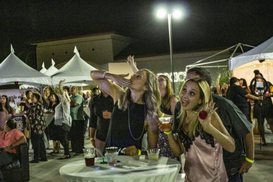 Guests enjoy a sampling of food and drinks from local eateries at "Cocktails on The Roof," an event benefiting the WiSH Foundation, on September 6, 2019. | Photo: Bobby Block/The Signal.