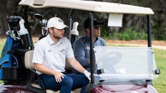 master's men's golf player in a cart