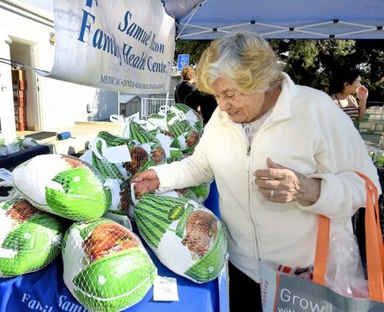 Maria Guidino picks up one of the 124 donated turkeys handed out at the Samuel Dixon Family Health Center in Val Verde on Friday, November 22, 2019. | Photo: Dan Watson / The Signal.