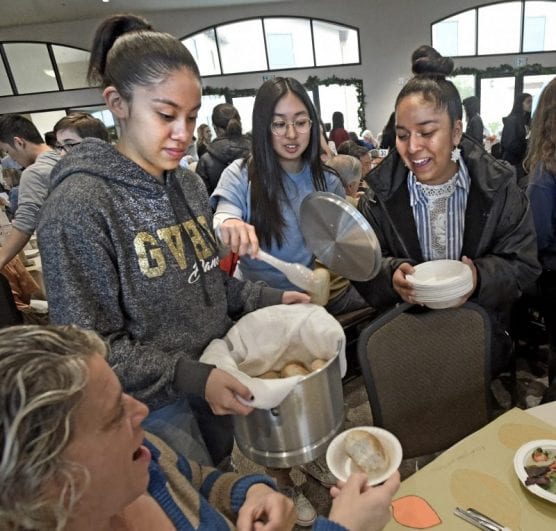 Golden Valley High School students, from left, Alicia Ulloa, Calissa Trongnetrpunya and Herione Quintos serve rolls during the Senior Center Thanksgiving Gourmet Feast and Party held at the Santa Clarita Valley Senior Center at Bella Vida on Thursday, November 28, 2019. | Photo: Dan Watson / The Signal.
