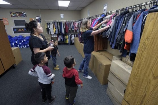 District Coordinator of Special Programs Sarah Johnson, right, shows Maria Velez and her three sons, from left, Jaden, Steven and Hector Lemus the coats available as they are the first family to visit the Wiley Canyon Elementary School Family Resource Center in Newhall on Thursday, November 21, 2019. | Photo: Dan Watson / The Signal.