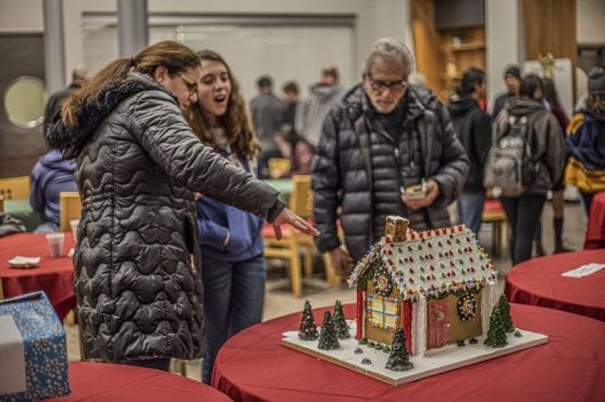Leslie Babikan evaluates one of the entries in the College of the Canyons Gingerbread House Display and Competition held in the school's Culinary Arts building Wednesday night, December 4, 2019. | Photo: Bobby Block / The Signal.