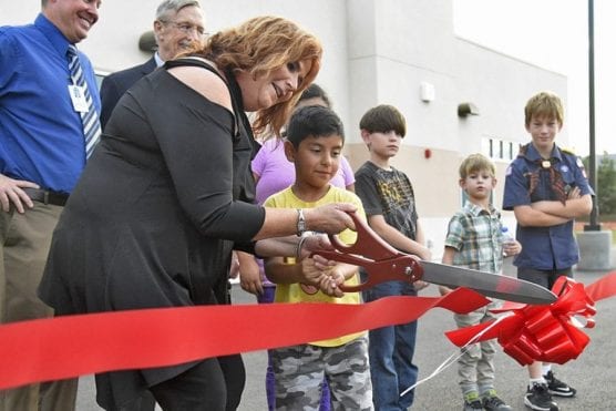 Old Orchard Elementary School Principal Ken Hintz, left, looks on as Governing Board President Sue Solomon and first-grade student Javier Arista cut the ribbon during the official ceremony for the opening of two new permanent modular buildings at Old Orchard Elementary School in Newhall on Monday. | Photo: Dan Watson / The Signal.