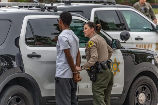 A suspect is detained by Los Angeles County Sheriff's deputies in connection with a robbery on the 27800 block of Glasser Avenue in Canyon Country Tuesday afternoon. | Photo: Cory Rubin/The Signal.