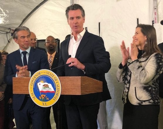 California Gov. Newsom talks to reporters in East Oakland, wrapping up a statewide homelessness tour. Newsom is flanked by Assemblyman Rob Bonta, D-Alameda, and Oakland Mayor Libby Schaaf. | Photo: Nicholas Iovino / CNS.
